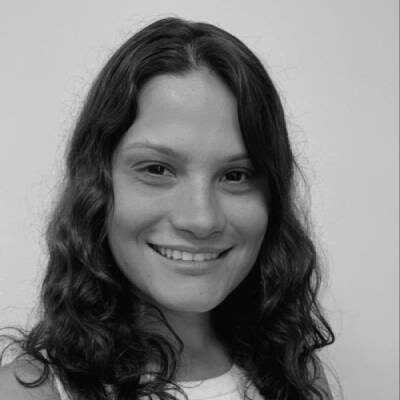 A woman with long hair smiling for the camera.